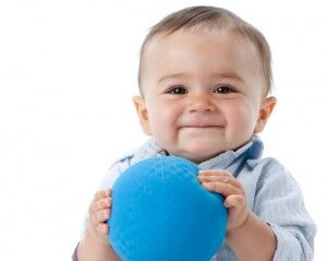 Real People: Headshot Smiling Caucasian Toddler Boy Holding Ball