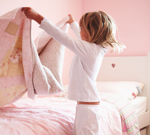 Young Girl Making Her Bed