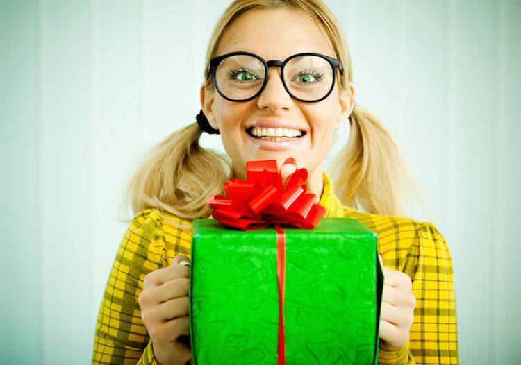 Woman nerd holding a present.